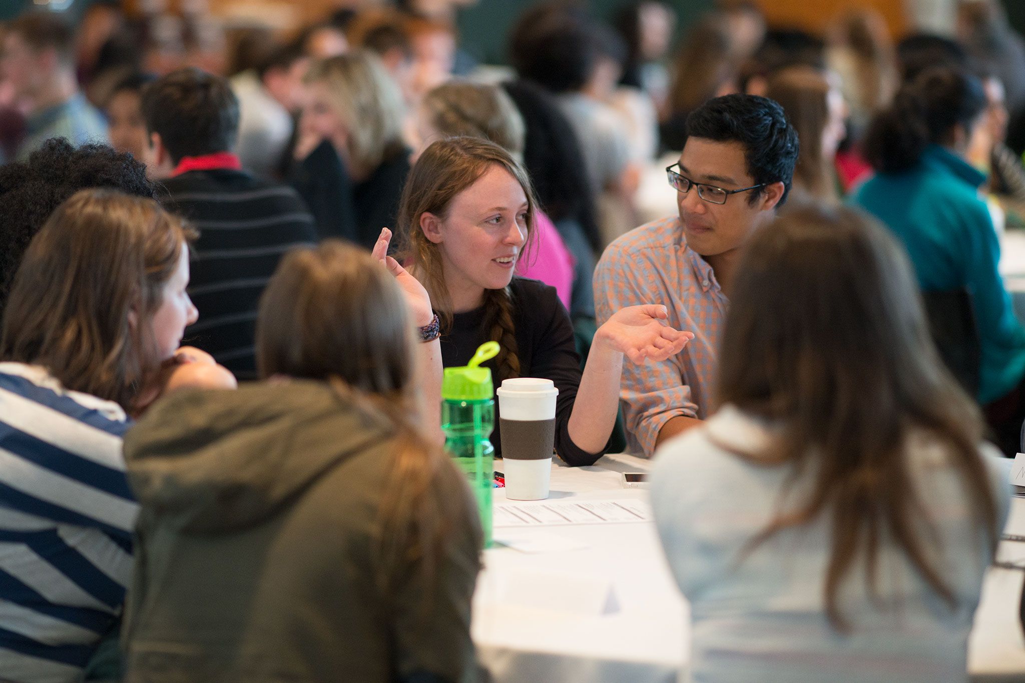 Students chat around a table