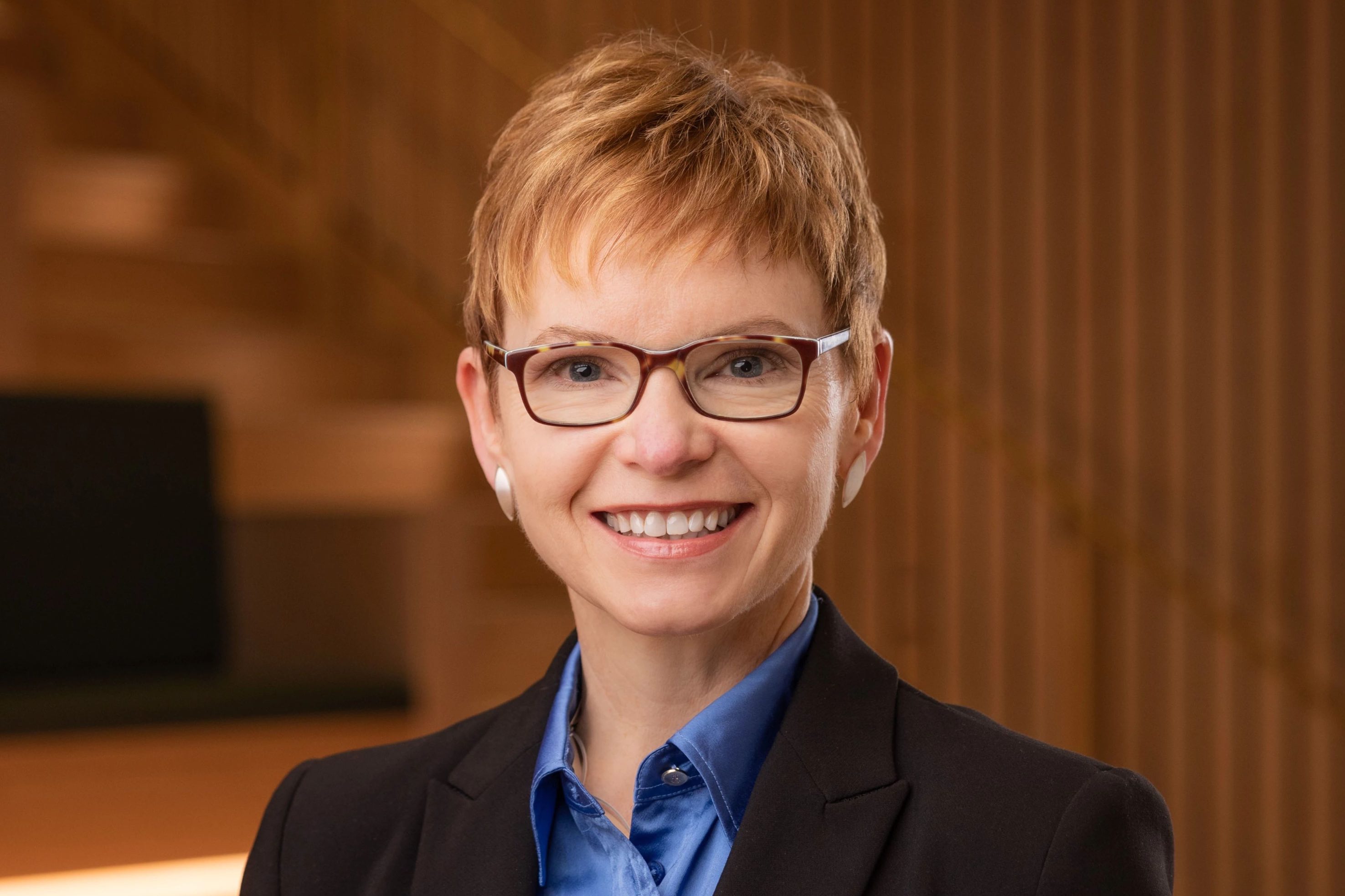 Smiling woman in glasses with pixie cut