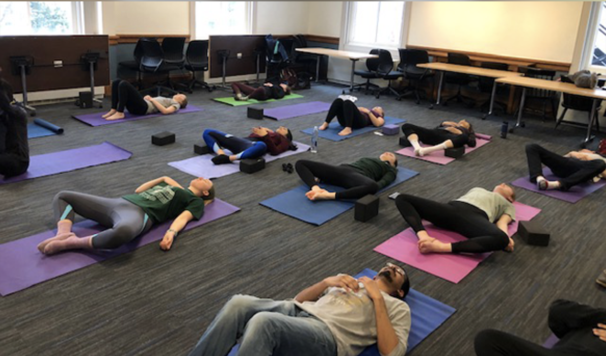 People laying on mats doing yoga